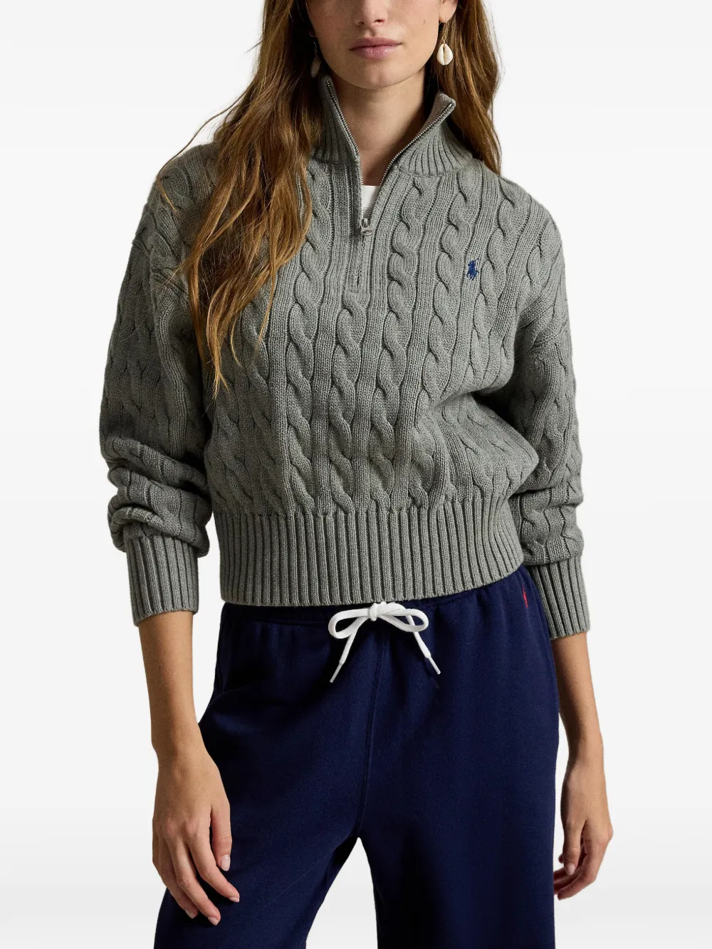 Grey knitwear worn by a person, showing the knitwear fit