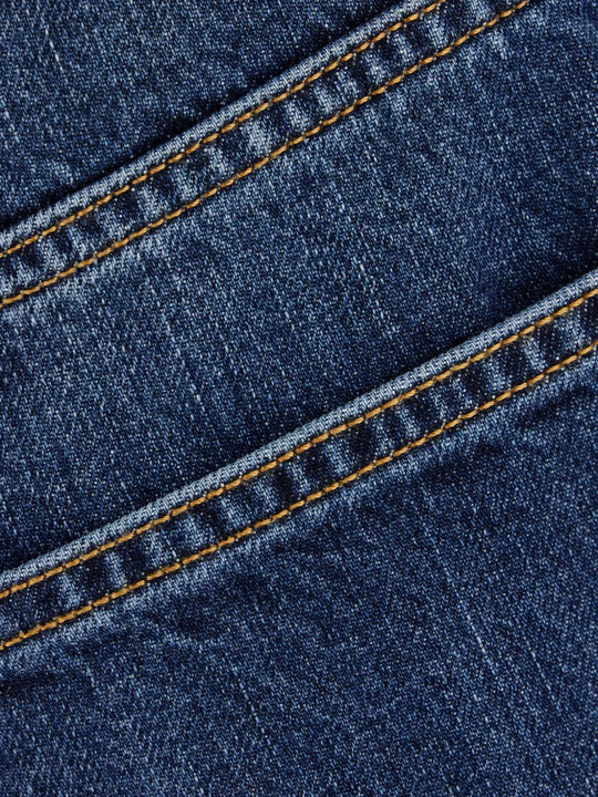 Close up of the blue jeans, showing texture of the cotton fabric