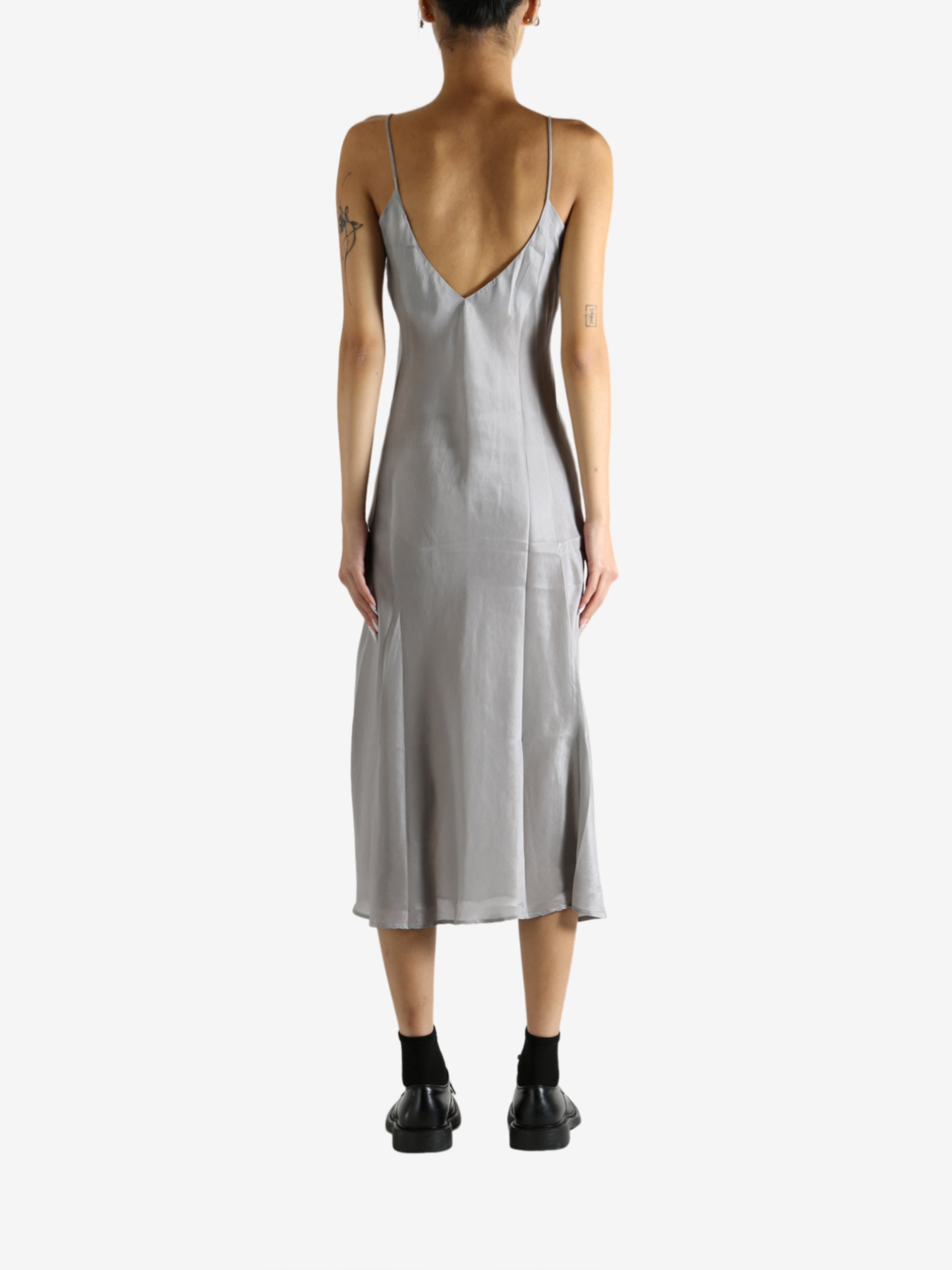 Grey dress worn by a person, showing the dress's fit