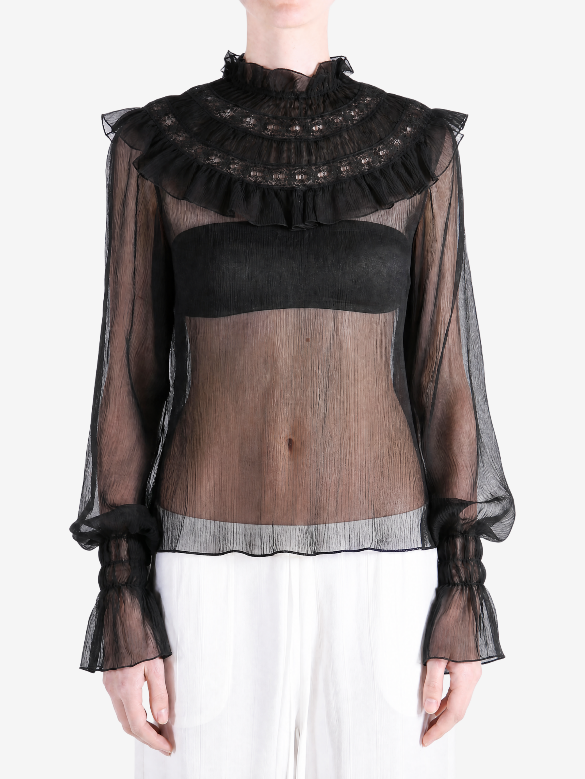 Black top worn by a person, showing the top fit