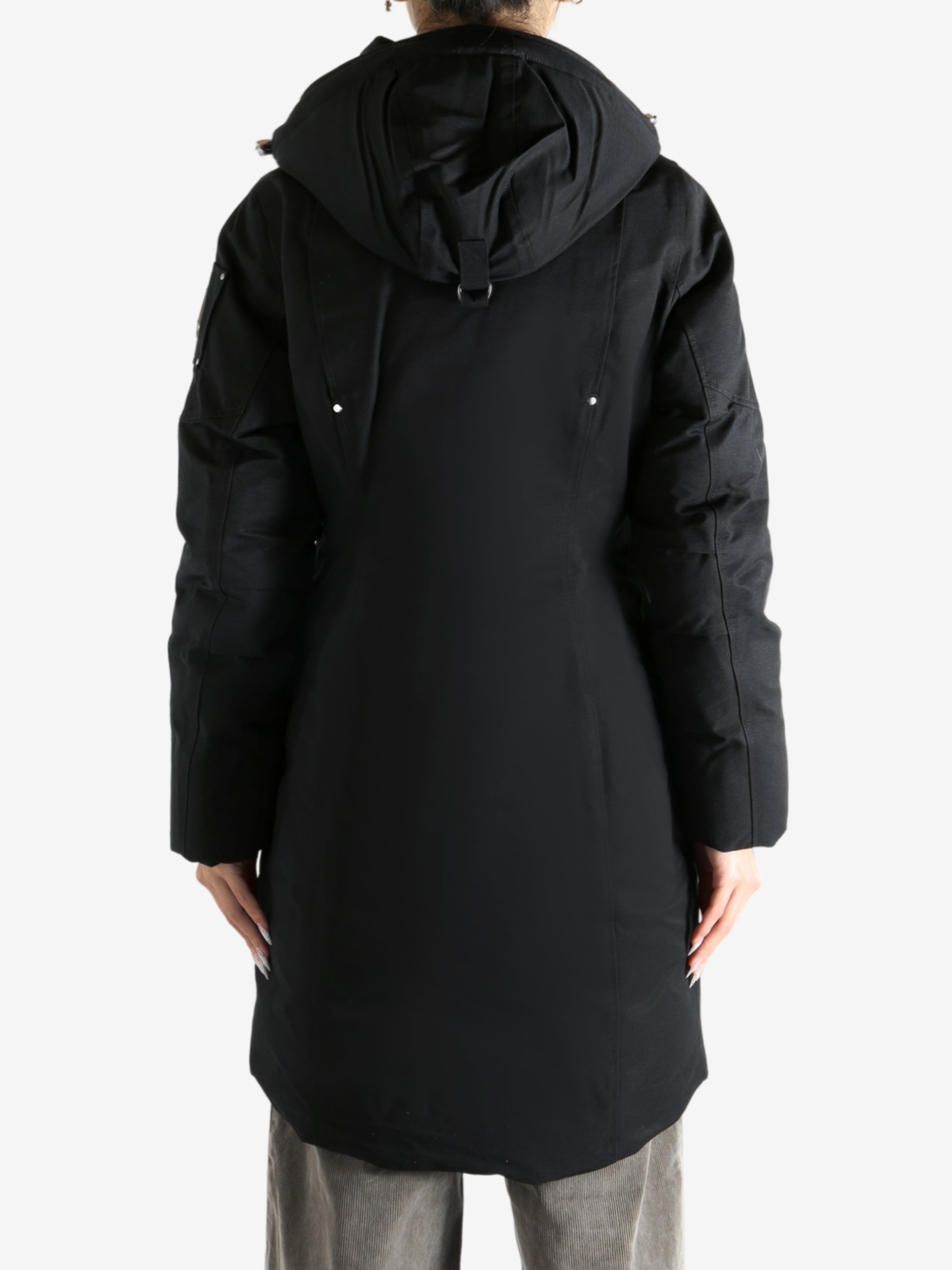 Black parka worn by a person, showing the parka fit