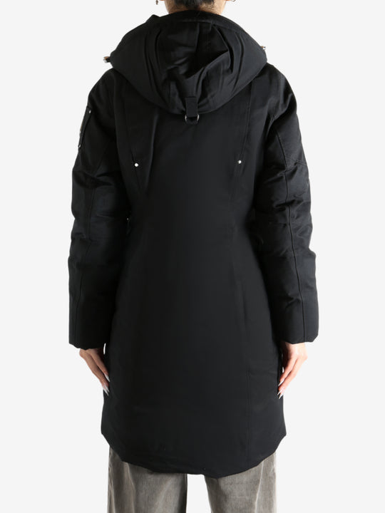 Black parka worn by a person, showing the parka fit