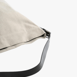 Close up of the grey bag, showing texture of the cotton fabric