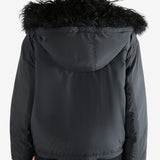 Black coat worn by a person, showing the coat's fit