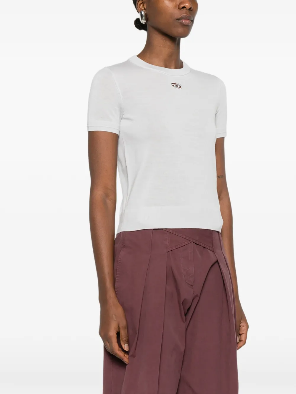 white knitwear worn by a person, showing the knitwear fit