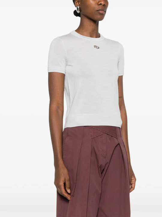 white knitwear worn by a person, showing the knitwear fit