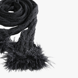 Close up of black scarves, showing texture of the cotton fabric