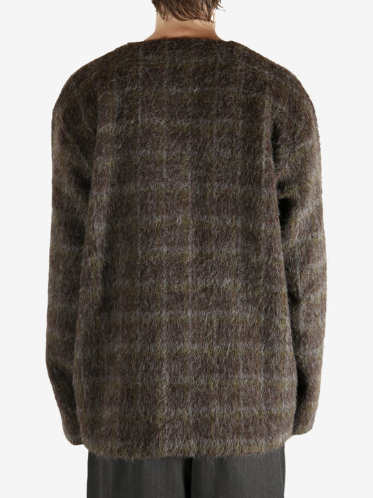 Brown knitwear worn by a person, showing the knitwear's fit