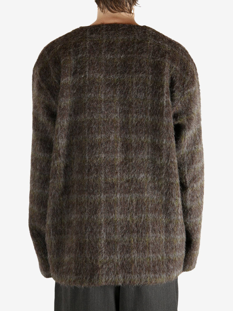 Brown knitwear worn by a person, showing the knitwear's fit