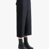 Black pants worn by a person, showing the pants's fit