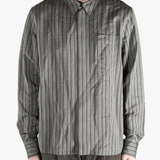 Grey shirt worn by a person, showing the shirt's fit