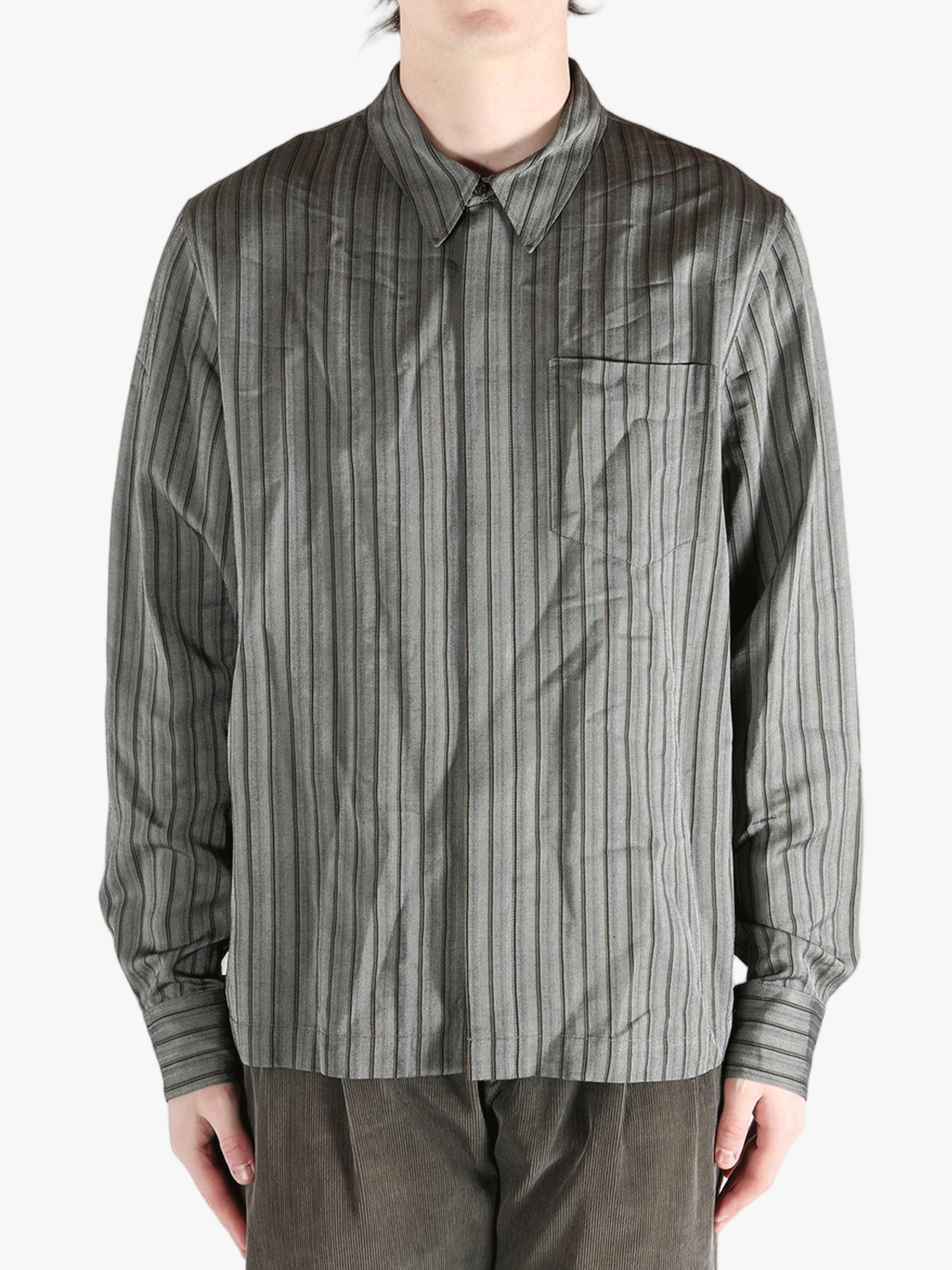 Grey shirt worn by a person, showing the shirt's fit