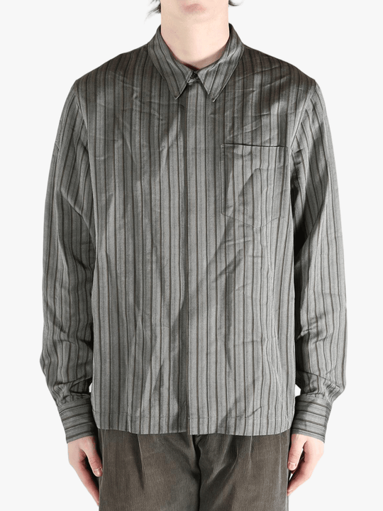 Grey shirt worn by a person, showing the shirt's fit