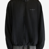 Black coat worn by a person, showing the coat's fit