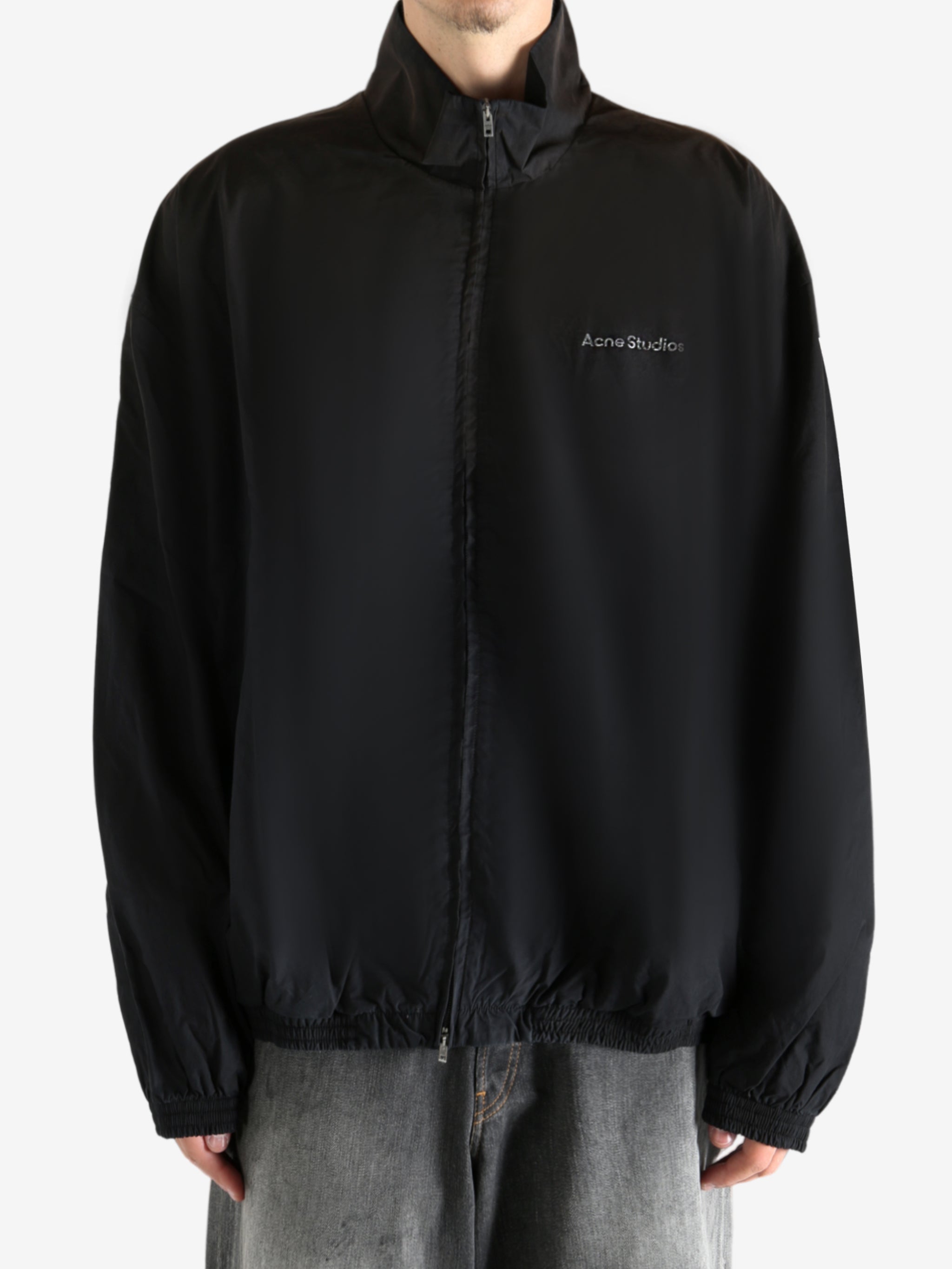 Black coat worn by a person, showing the coat's fit