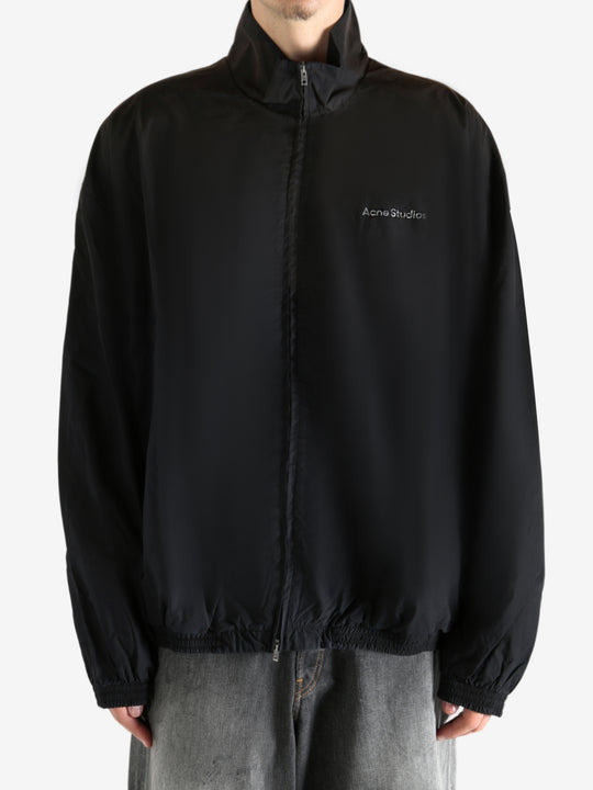 Black coat worn by a person, showing the coat's fit