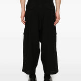 Black pants worn by a person, showing the pants's fit