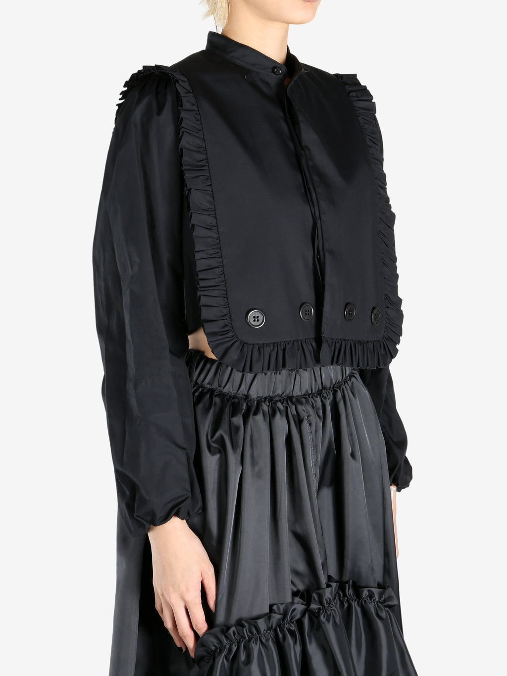 Black tops worn by a person, showing the tops fit