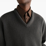 Grey knitwear worn by a person, showing the knitwear fit