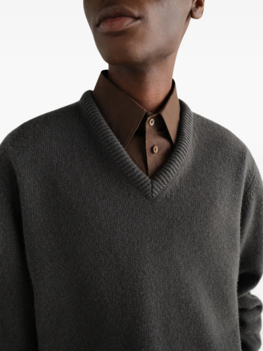 Grey knitwear worn by a person, showing the knitwear fit