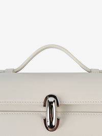 Close up of beige handbag, showing texture of the calfskin fabric