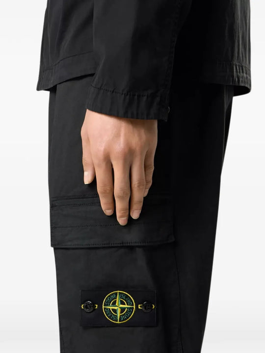 Black pants worn by a person, showing the pants fit