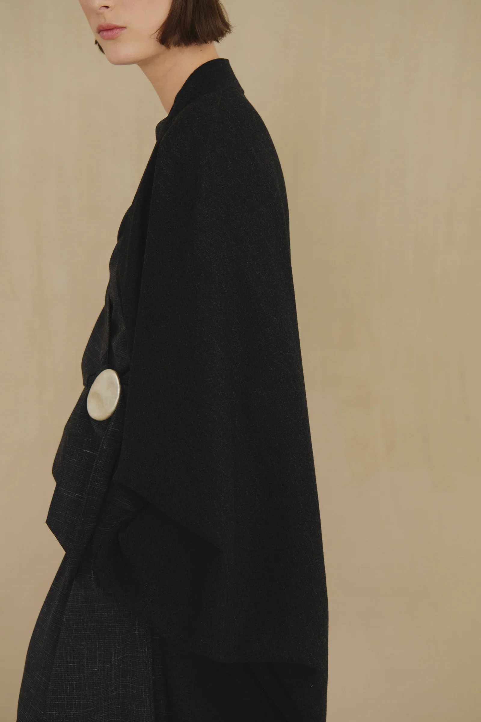 Black jacket worn by a person, showing the jacket fit