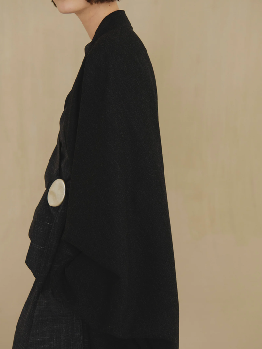 Black jacket worn by a person, showing the jacket fit