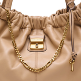 Close up of brown bags, showing texture of the lamb leather fabric