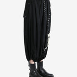 Black pants worn by a person, showing the pants fit