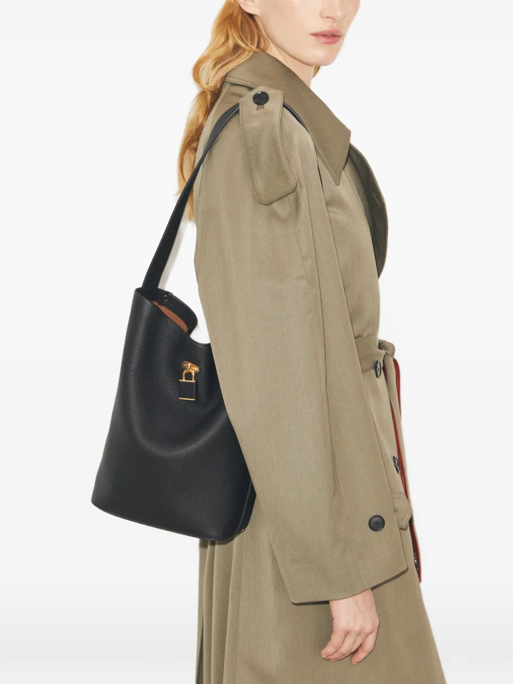 Black bucket bag by a person, showing the bucket bag fit