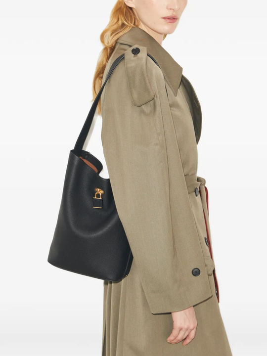 Black bucket bag by a person, showing the bucket bag fit