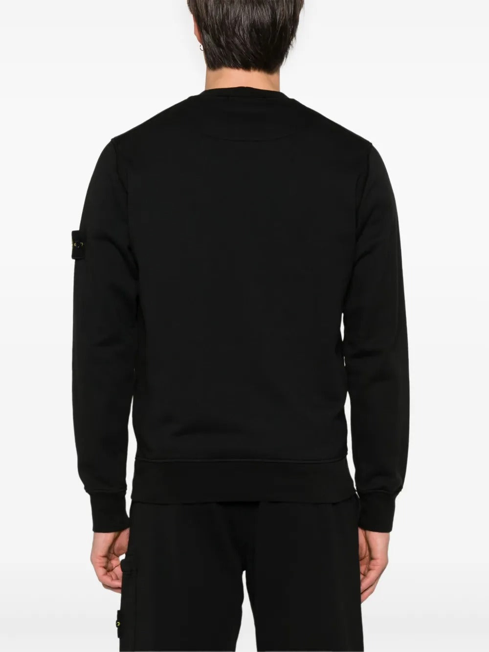 Black sweatshirt worn by a person, showing the sweatshirt fit