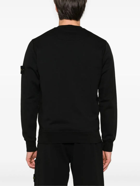 Black sweatshirt worn by a person, showing the sweatshirt fit