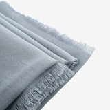 Close up of grey scarves, showing texture of the wool fabric