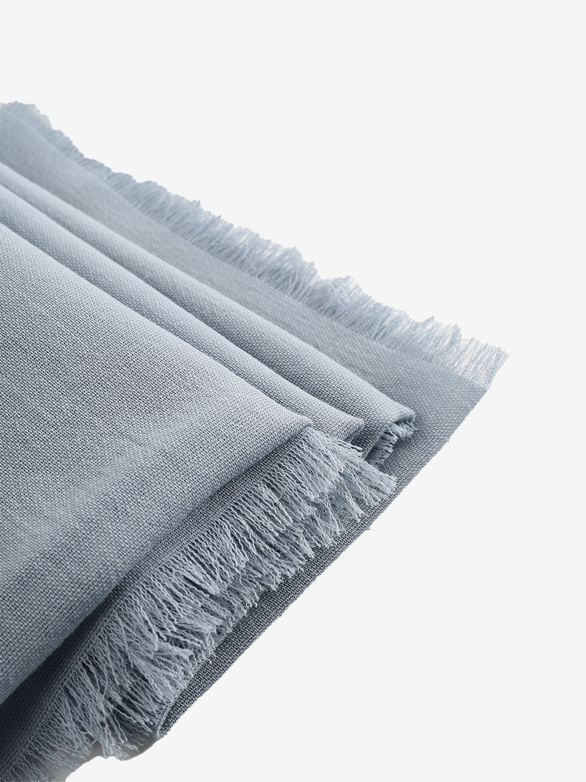Close up of grey scarves, showing texture of the wool fabric