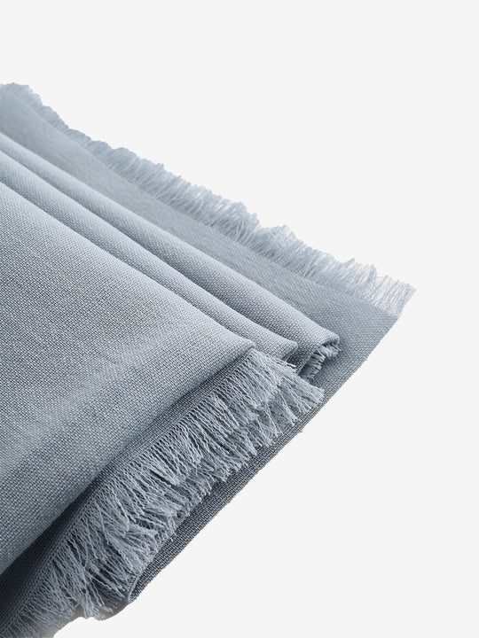 Close up of grey scarves, showing texture of the wool fabric