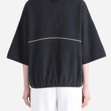 Black shirts worn by a person, showing the shirts' fit 