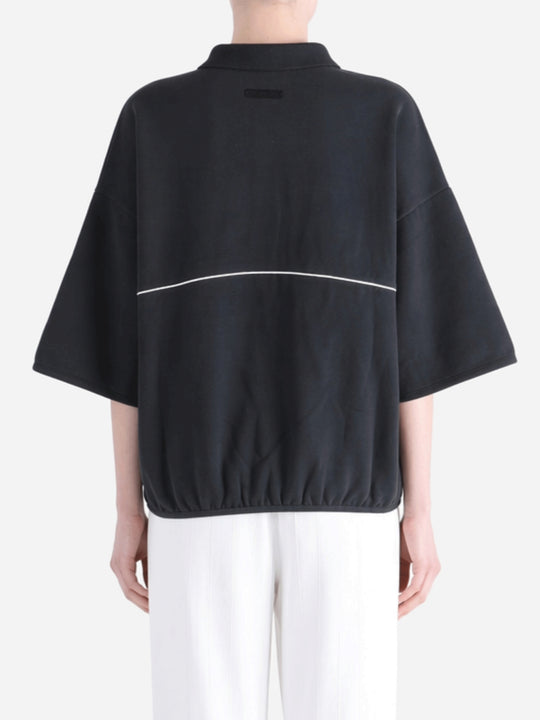 Black shirts worn by a person, showing the shirts' fit 