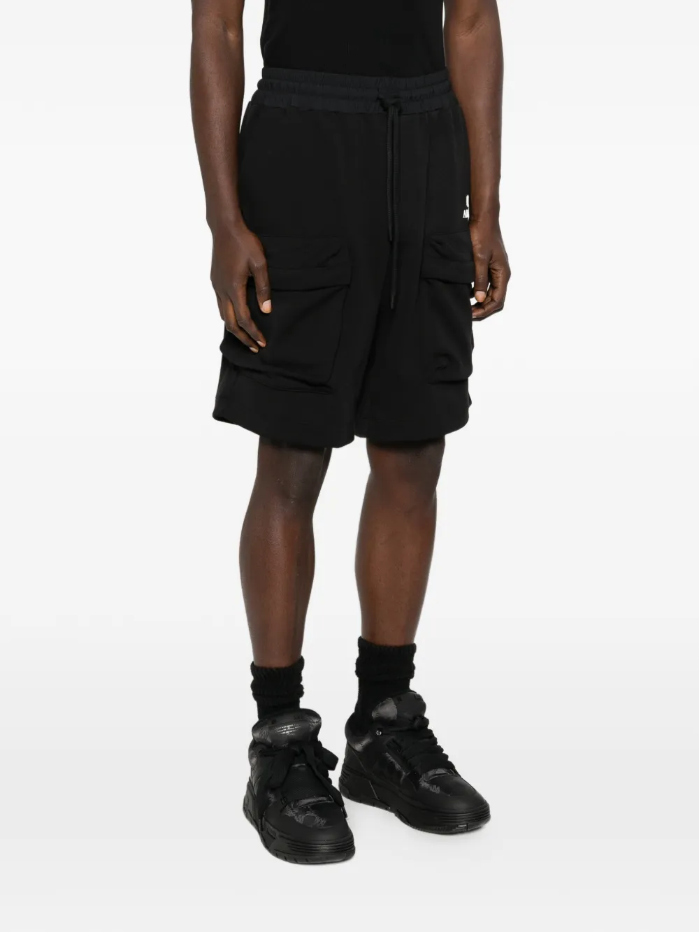 black shorts worn by a person, showing the shorts fit