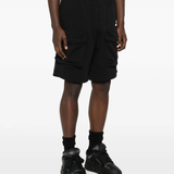 black shorts worn by a person, showing the shorts fit