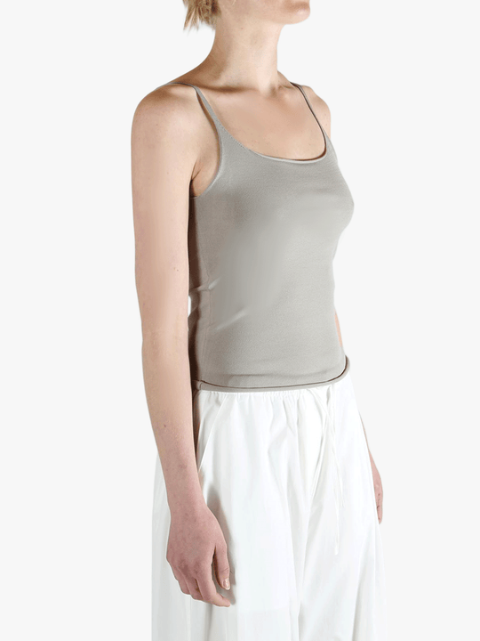 Grey tops worn by a person, showing the tops fit