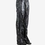 Black pants worn by a person, showing the pants' fit