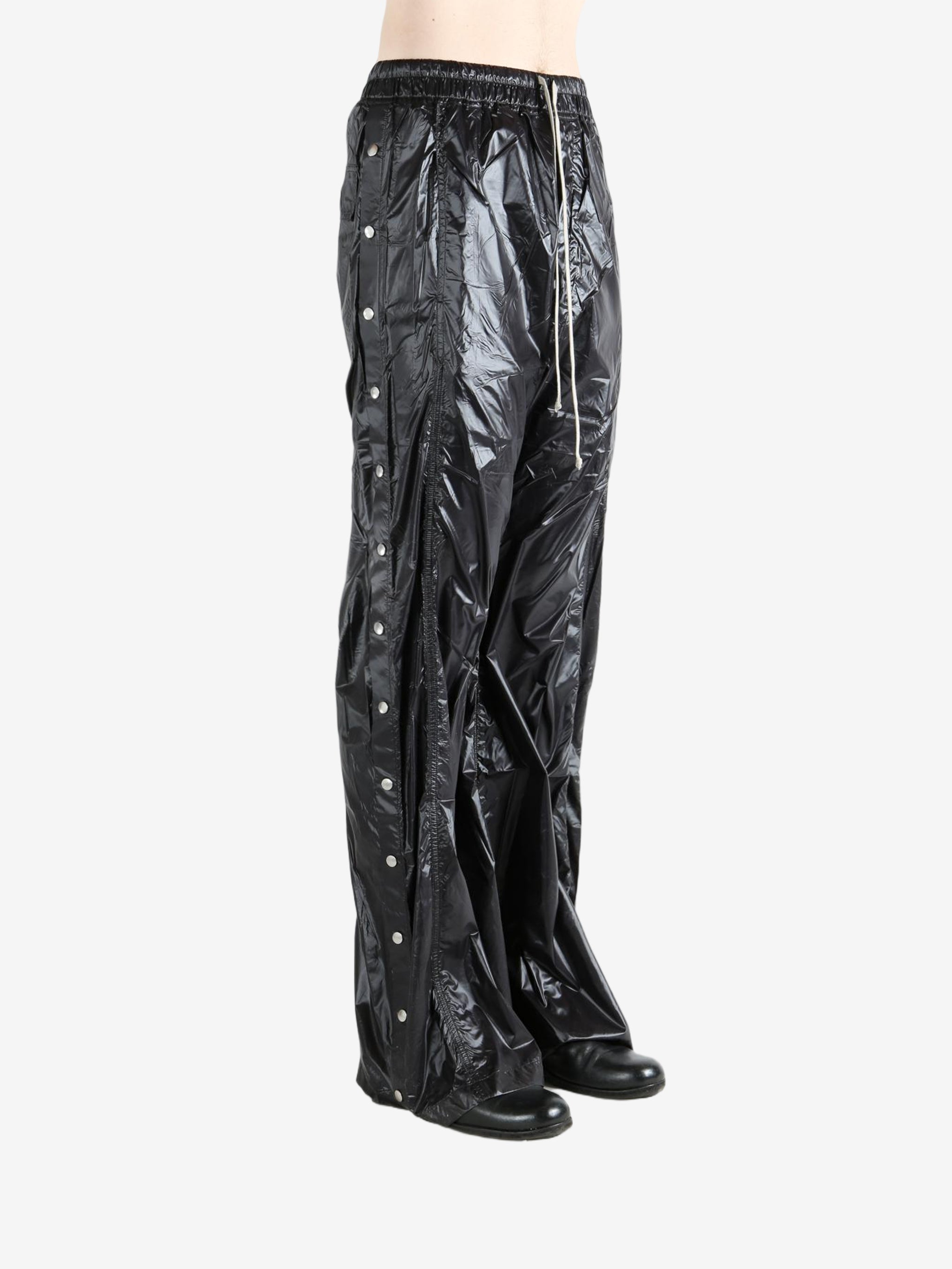 Black pants worn by a person, showing the pants' fit