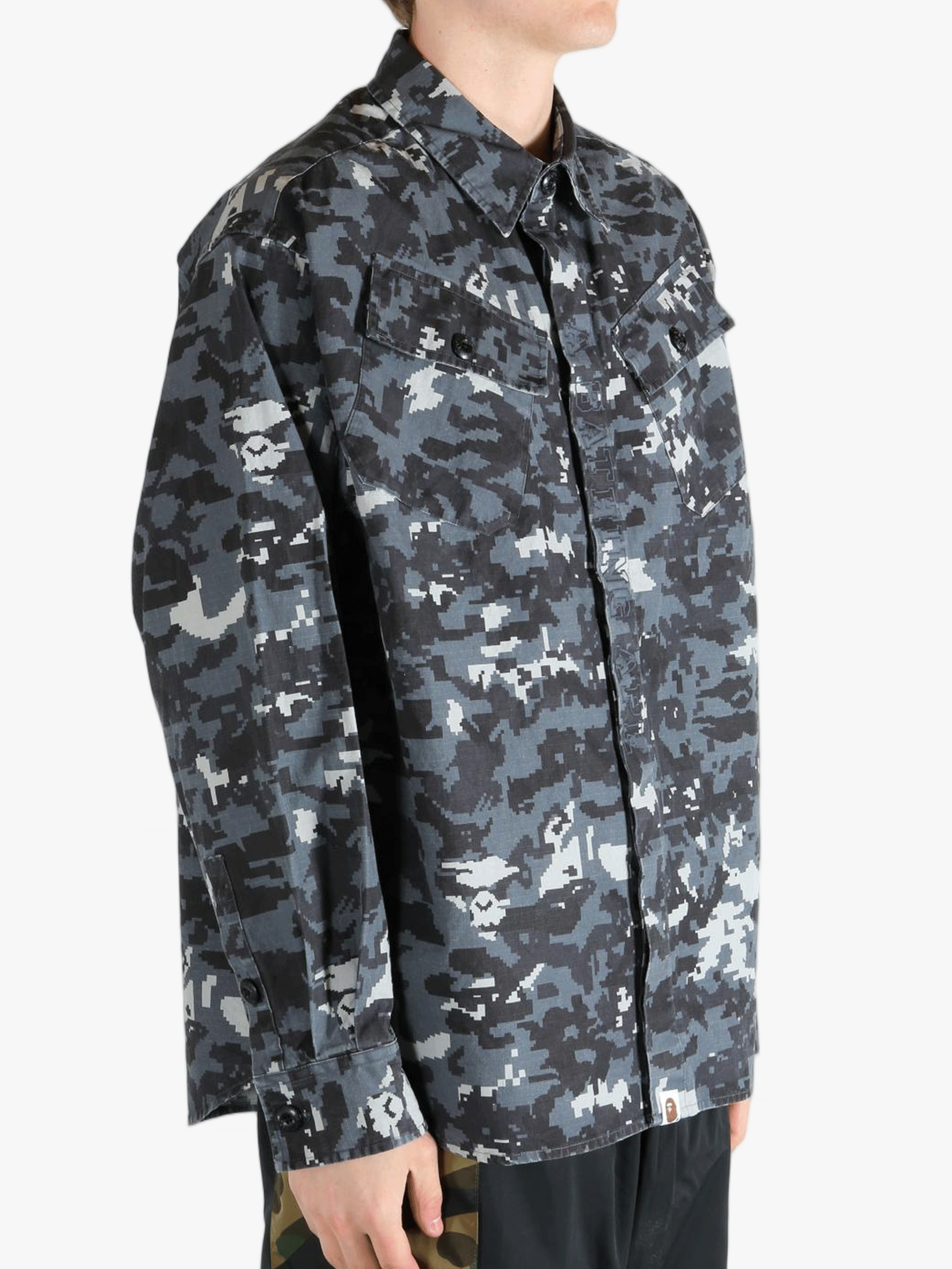 Black shirt worn by a person, showing the fit