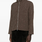 Brown coat worn by a person, showing the coat's fit