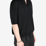 Black T-shirt worn by a person, showing the shirt’s fit
