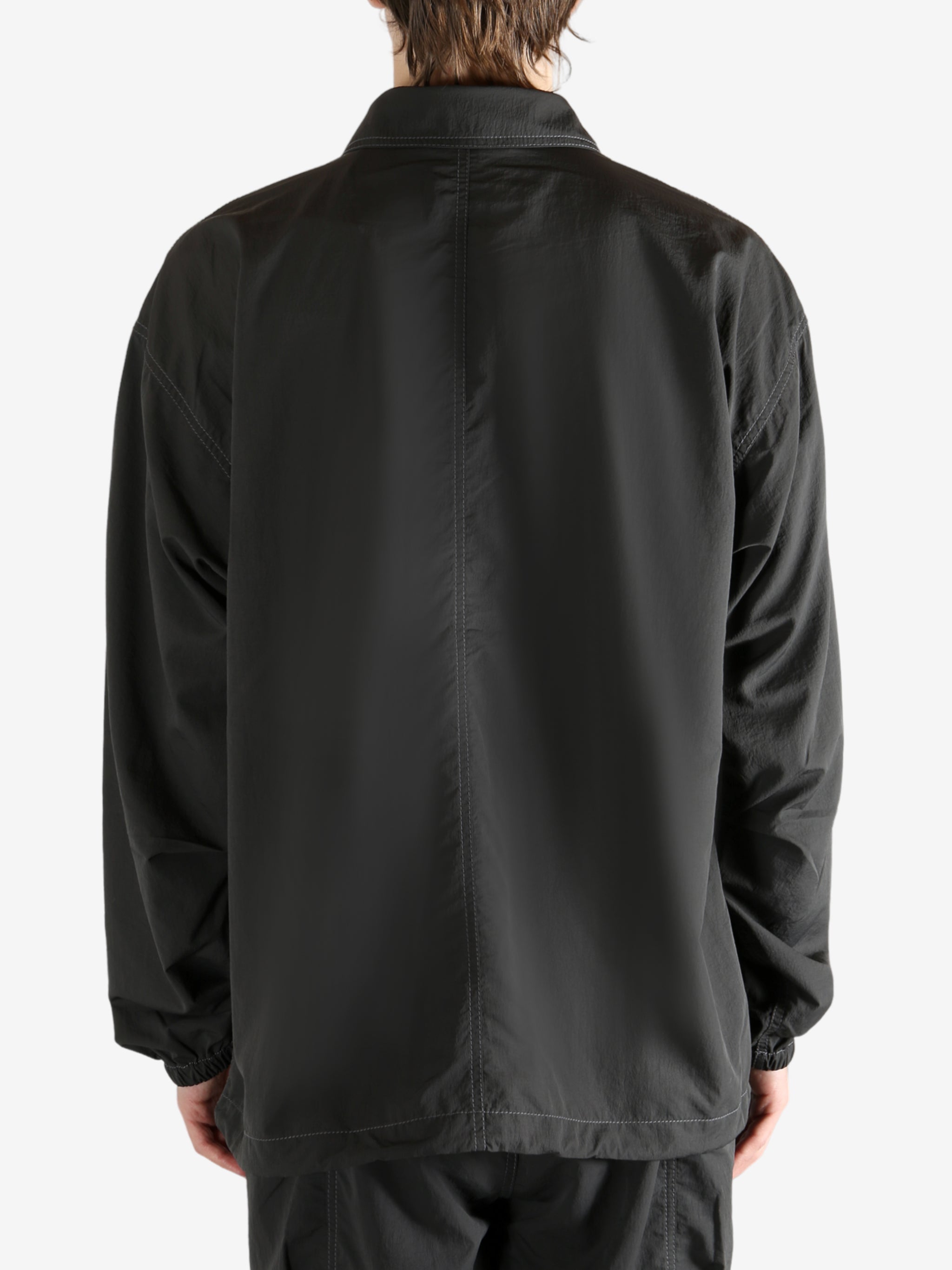 Black jacket worn by a person, showing the jacket fit