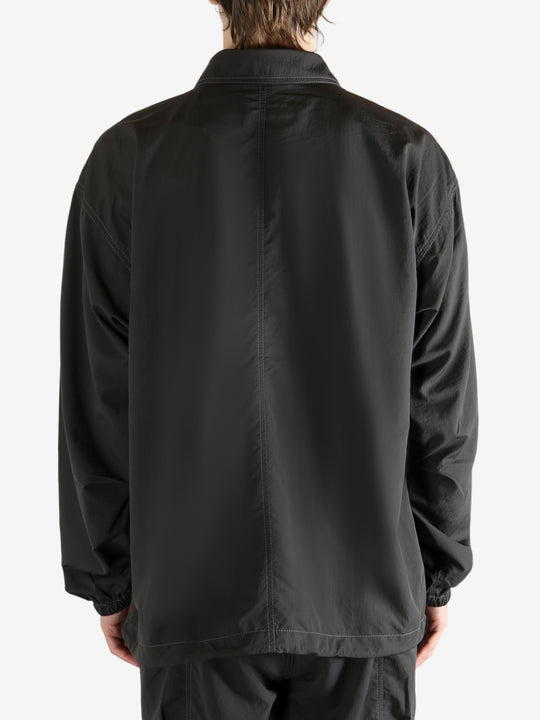 Black jacket worn by a person, showing the jacket fit