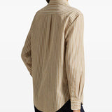 Tan shirt worn by a person, showing the shirt's fit
